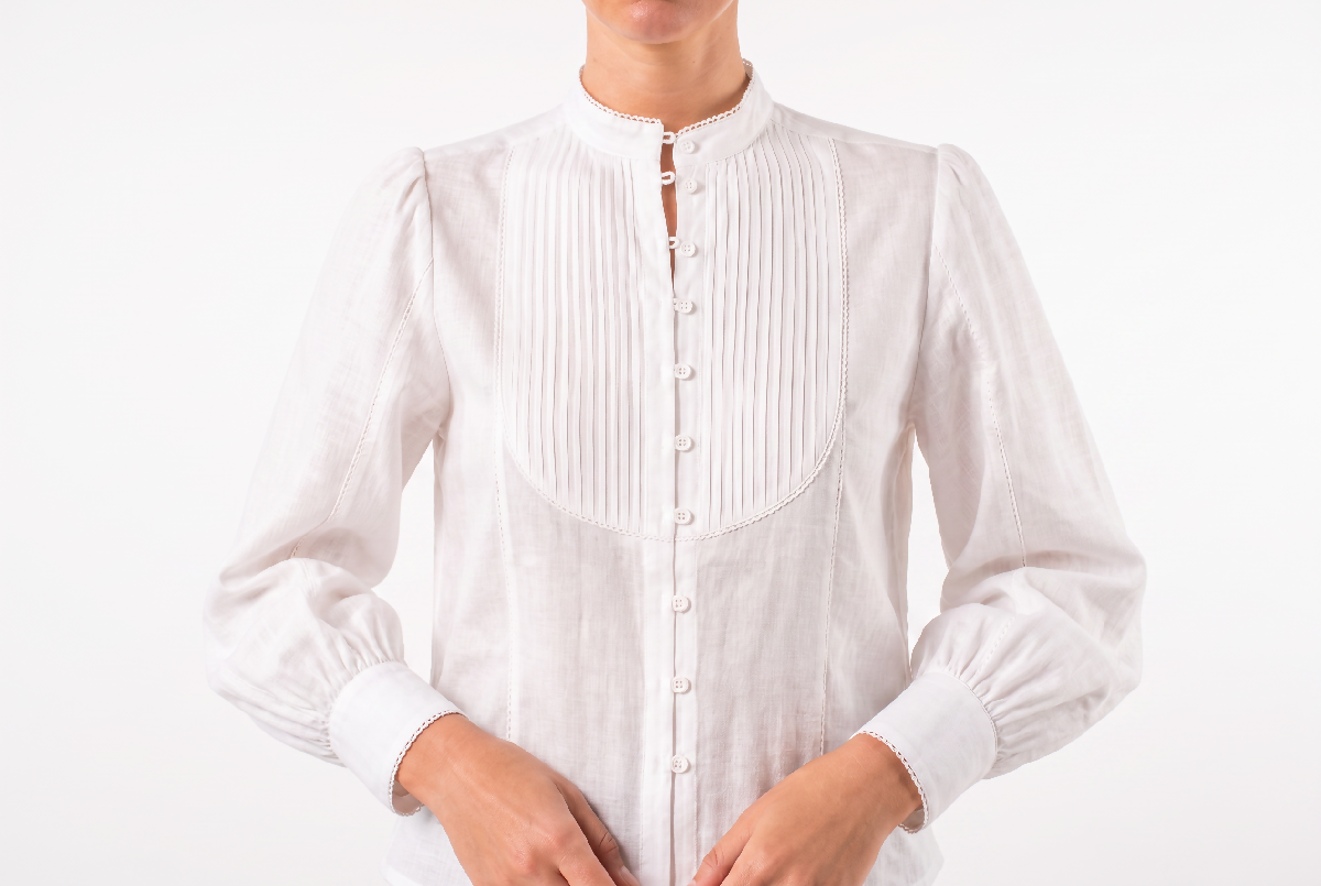 Generated with Kive.ai - Remove all visible cast shadows from Image 1 and make the background clean_ evenly lit white. Keep the blouse_ cropped model_ pose_ framing_ proportions_ fabr