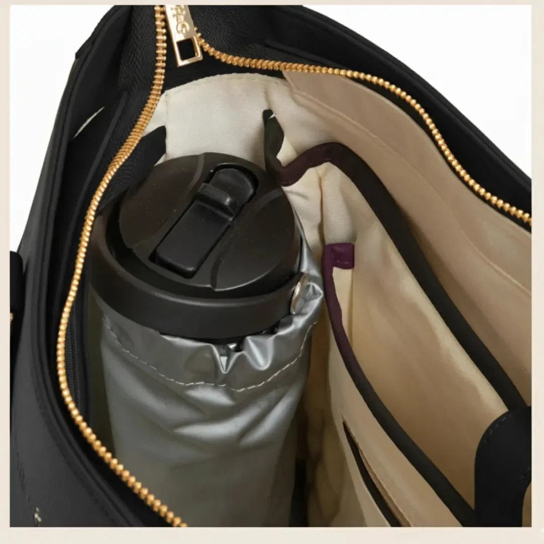 Open interior of the Charcoal Iluka Tote — laptop sleeve, insulated pockets and organiser panels