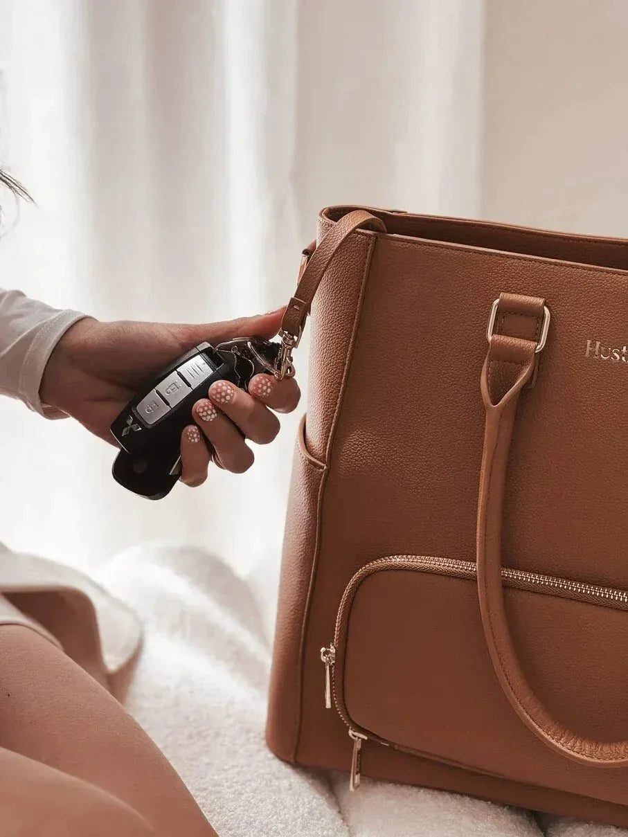 Key leash and wipeable makeup pouch inside the Driftwood Iluka Executive Tote